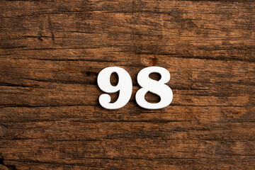 Number 98 - piece on rustic wood background