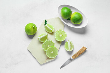 Composition with juicy bergamot fruits and knife on light background