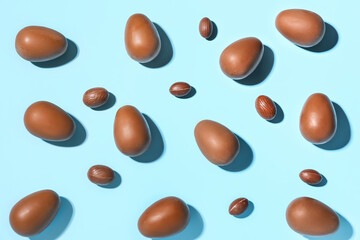 Delicious chocolate eggs on blue background