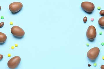 Delicious chocolate eggs on blue background