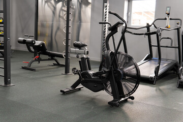 Obraz premium Air bike gym exercise fit, from female endurance from lifestyle and club equipment, person power. Sportswear exercising riding, determined