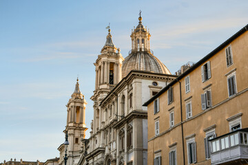 The dome and towers of the Sant'Agnese in Agone, or St. Agnes Cathedral as the sun sets over the Piazza Navona in the historic center of Rome, Italy	