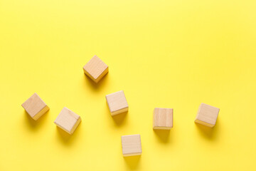 Fototapeta na wymiar Wooden cubes on yellow background