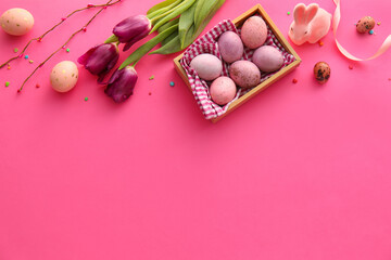 Beautiful Easter composition with eggs, tulip flowers and bunny on color background
