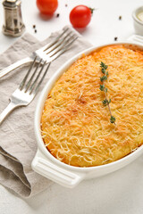Baking dish with tasty Shepherd's pie on white background, closeup