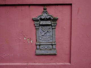 Historic cast iron mailbox (Portuguese Correio means post in English) on the house wall of an old...