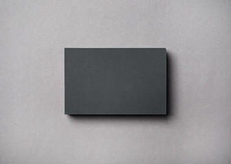 Blank gray business card on concrete background. Top view. Flat lay.
