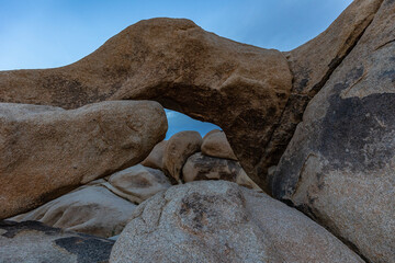 large rock formation in front of blue sky