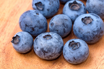 Harvested blueberry fruit (Wooden Plate Background)