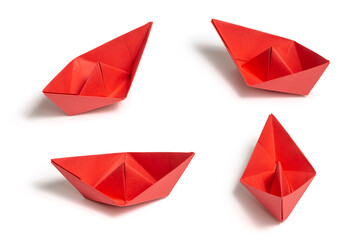 Four Red boats in different directions made from paper isolated on white background
