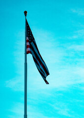American and Arizona Flag waving at sunset