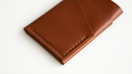 Empty men's business handmade leather card holder with isolated on white background. Selective focus, copy space, close up.