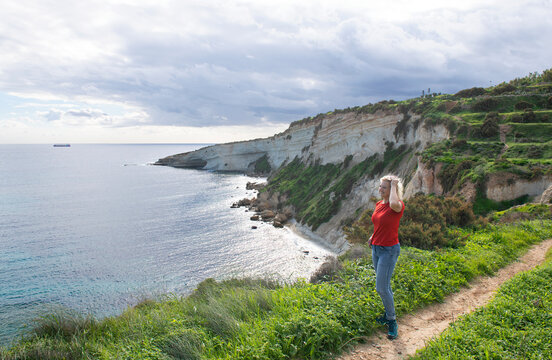 Woman standing on a footpath, Hal Far cliffs, Birzebbuga, Malta
