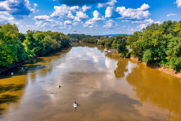 Brown water, trees and clouds River bridge