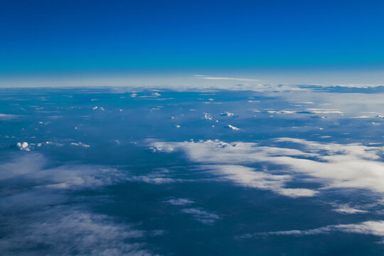 View of the city and mountains from above from a drone and an airplane. Cities aerial view, sky and clouds