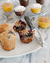  Two halves of blueberry muffin with fresh berries. Vegan muffin