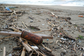 Old rusted spray can discarded on sea coast ecosystem,nature pollution contamination
