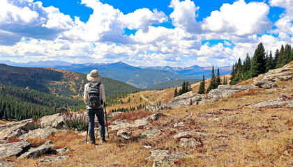 Hiker at Colorado's Ptarmigan Pass near Vail. - obrazy, fototapety, plakaty