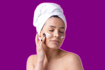 Beauty portrait of woman in white towel on head with a sponge for a body in view of a pink hearе on violet background.