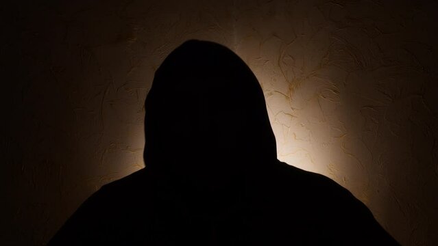 Silhouette of unknown male person over dark 