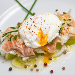Poached egg on a bed of leek and marinated fresh salmon, chive sauce