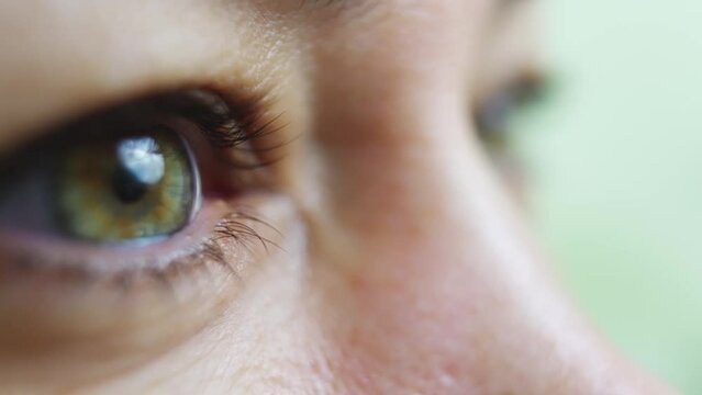 close-up. women's green eye squeezes hard s. ophthalmology 