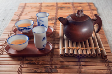 tea set on a table with a bamboo substrate