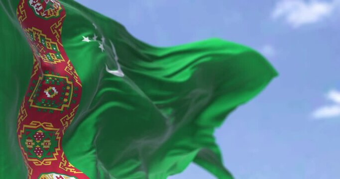 Detail of the national flag of Turkmenistan waving in the wind on a clear day