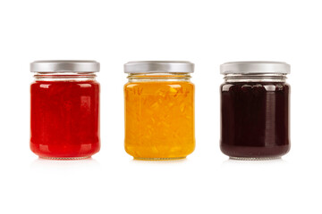 Three jars of Strawberry, orange, blueberry jam on white background.