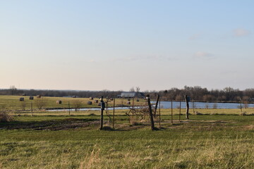 Garden with a Lake and Hay Bales in the Distance