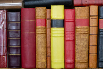 stack of old books on a shelf