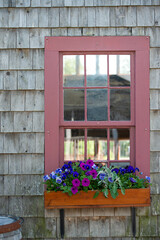 Fototapeta na wymiar Barn window with flower box 