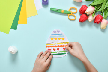 Children's postcard made of paper chicken in an Easter egg.