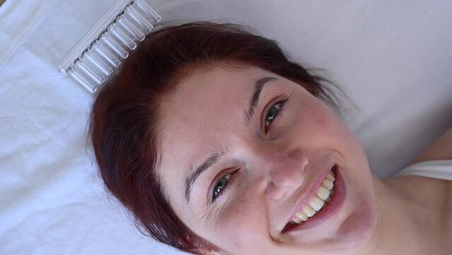 Caucasian woman on a hair care procedure using the Darsonval apparatus.