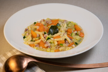 Fresh Vegetable soup and pasta in a white bowl