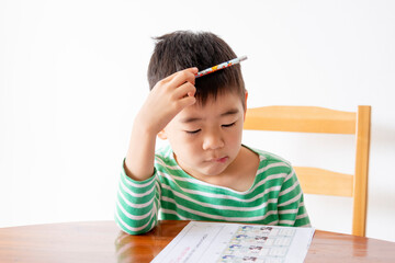 Little asian boy studying at home