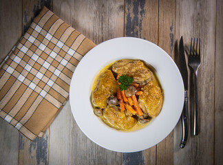 Recipe for chicken fricassee in white wine, with a carrot and mushroom planter
