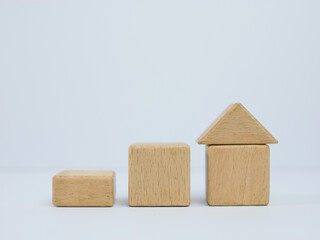 stairs made of wooden cubes with a house on top. investment insurance and home purchase mortgage real estate concept