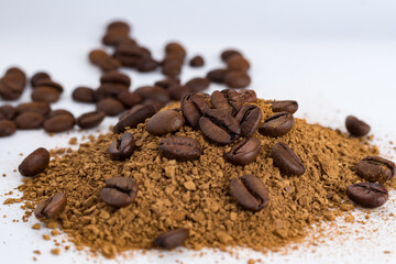 Pile of powdered, instant coffee and beans coffee isolated on white background. Love coffee concept