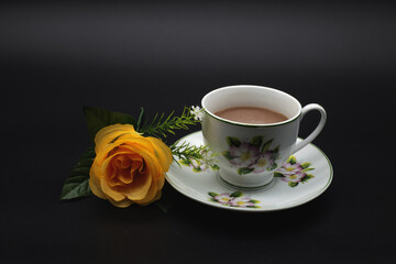 Obraz premium coffee in white flower mug Black background includes Clipping Path.