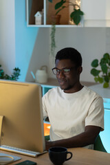 Thoughtful program developer work on computer. Serious african american programmer try to find...