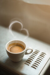 fresh cup of coffee on coffee machine