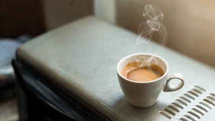 fresh cup of coffee on coffee machine