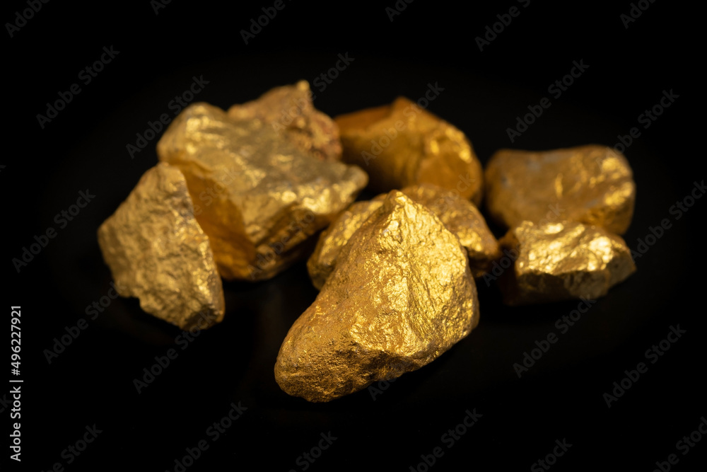 Wall mural The pure gold ore found in the mine on black background