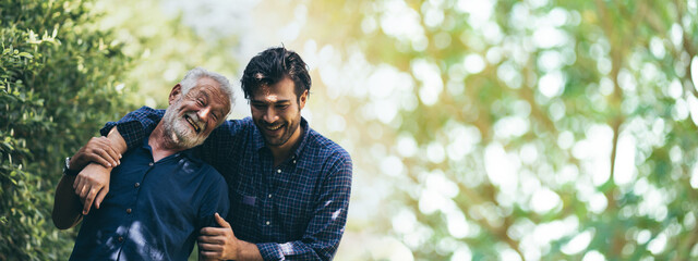 senior father hugging adult hipster son, have a happy feeling together, elderly caucasian person...