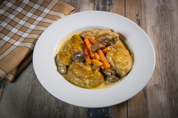 Recipe for chicken fricassee in white wine, with a carrot and mushroom planter