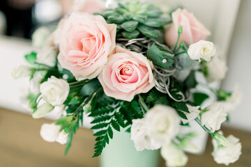 Obraz na płótnie Canvas Wedding flowers, bridal bouquet closeup. Decoration made of roses, peonies and decorative plants, close-up, selective focus.