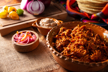 Cochinita Pibil. Typical Mexican stew from Merida, Yucatan, made from pork marinated with achiote and generally accompanied with beans and red onion with habanero chili, it can be eaten in tacos.