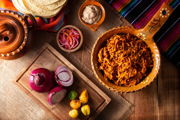 Cochinita Pibil. Typical Mexican stew from Merida, Yucatan, made from pork marinated with achiote and generally accompanied with beans and red onion with habanero chili, it can be eaten in tacos.