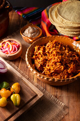 Cochinita pibil. Typical Mexican stew from Merida, Yucatan, made from pork marinated with achiote and generally accompanied with beans and red onion with habanero chili, it can be eaten in tacos.